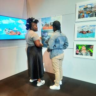Barbadian artist Kia Redman speaking about her work in the Fresh Milk booth at the inaugural FUZE Art Expo, Baha Mar, The Bahamas. Photo courtesy of Fresh Milk.